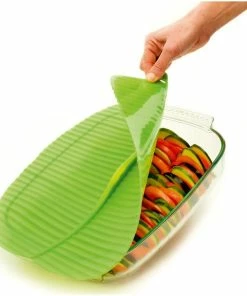 Charles Viancin Silicone Banana Leaf Baking Lid - Square, 10" X 10" 9 Charles Viancin Silicone Banana Leaf Baking Lid - Square, 10" X 10" -Cookware Sets Shop charles viancin banana leaf baking cover action shot compressed